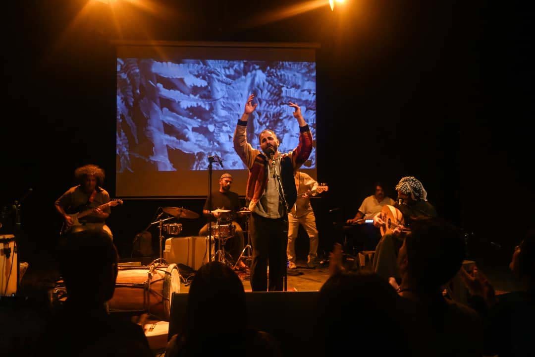 Kamakan performing live with a full band on stage